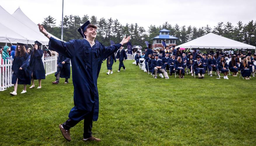 Merrimack Valley graduate Gavin Pesula throws his arms out to family and friends as he walks to get his diploma Saturday.