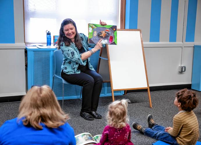 Concord reference librarian Robbin Bailey reads to the young children upstairs at the library.