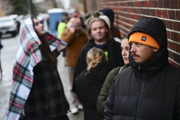Chance Lenay waits in line to vote outside the Gallatin County Courthouse on Election Day in Bozeman, Mont., on Tuesday, Nov. 5, 2024. (AP Photo/Tommy Martino)