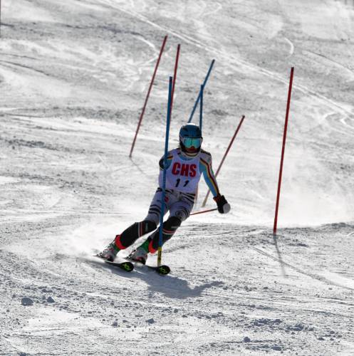 With her right arm in a sling and competing with just one pole, Concord High senior Ellie Worster skis through the slalom course at Pats Peak during Tuesday’s Division I Alpine championship. Worster suffered a shoulder injury during her second giant slalom run in the morning but pushed through the pain, helping the Crimson Tide to second place as a team.