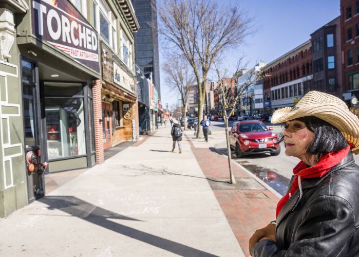 Deborah Eckland looks over at the place on Elm Street in Manchester that she used to hang out when she was homeless.