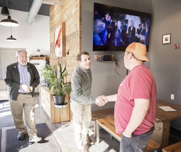 Tucker Jadczak, owner of Feathered Friend Brewing Co., greets U.S. Rep Chris Pappas and Concord Mayor Byron Champlin as they entered the brewery to talk about the tariff situation he has experienced.