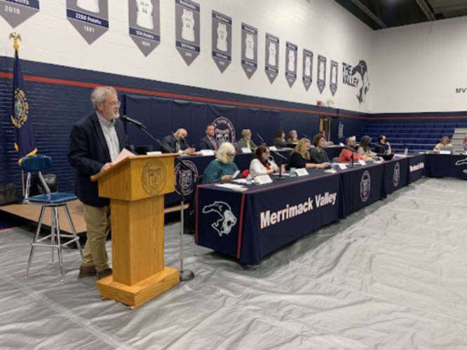 Moderator Charles Niebling addresses residents of the Merrimack Valley School District during the annual meeting in 2023 as board members and administrators look on.