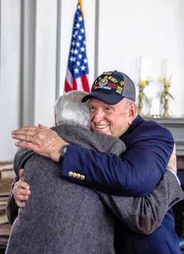 Jerry Lavigne gets a hug from his brother, Conrad, at his medal ceremony at Pleasant View Retirement Home on Saturday, February 24.