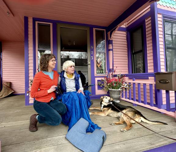 Barbara Filion and her daughter Marsha Filion enjoy a quiet morning on their front porch in Portsmouth with their neighbor’s dog.