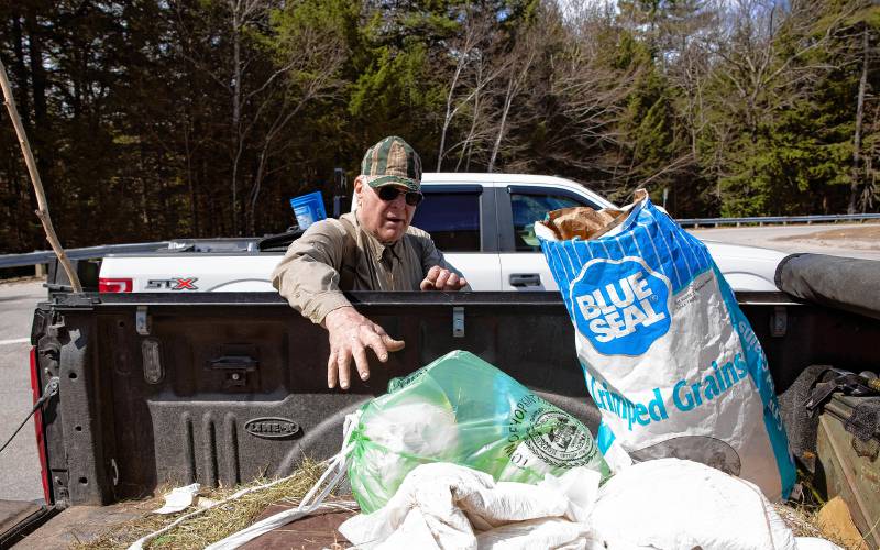 Brad Watson, a resident of Hopkinton for 50 years, gathers up his green bag for household items along with his agricultural waste items at the Hopkinton Transfer Station on Wednesday morning, April 17, 2024. Watson is not a fan of the green bags.