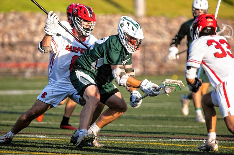 Hopkinton midfielder Jackson Westover battles against Campbell at the Div.III semifinals at Bank of NH Stadium in Laconia on Wednesday, June 5, 2024.