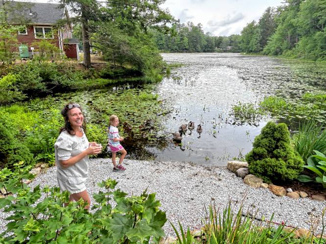 Shana Smith and her 7-year-old daughter feed cracked corn to the geese in their backyard.