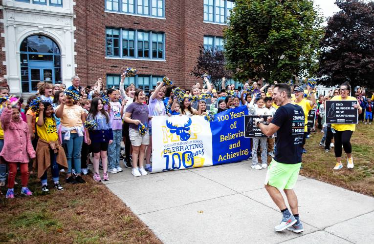 Matty Gregg is welcomed by the school children from Mount Pleasant School in Nashua on Thursday morning, October 3, 2024. Gregg is running the length of New Hampshire for child hunger.