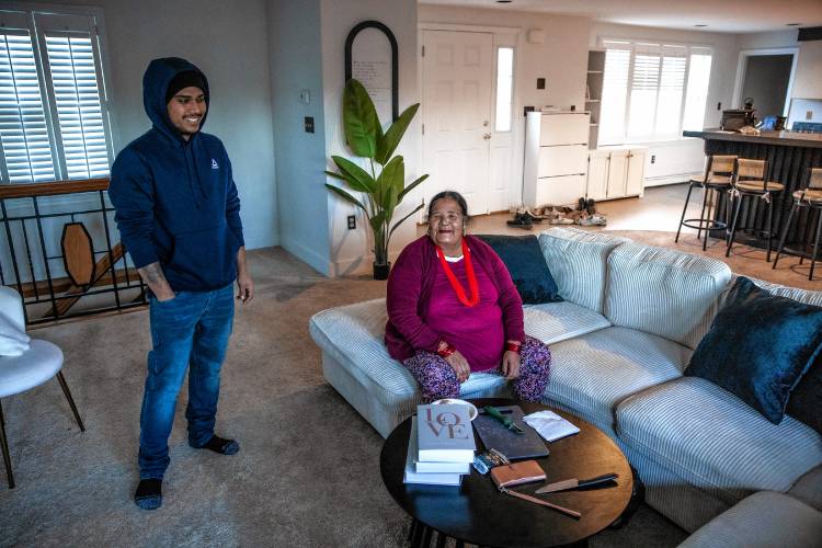 Shamir Darjee (left) and his grandmother, Aiti Darjee in the living area of his home on Noyes Street in Concord. Darjee recently bought the house and lives there with his family.