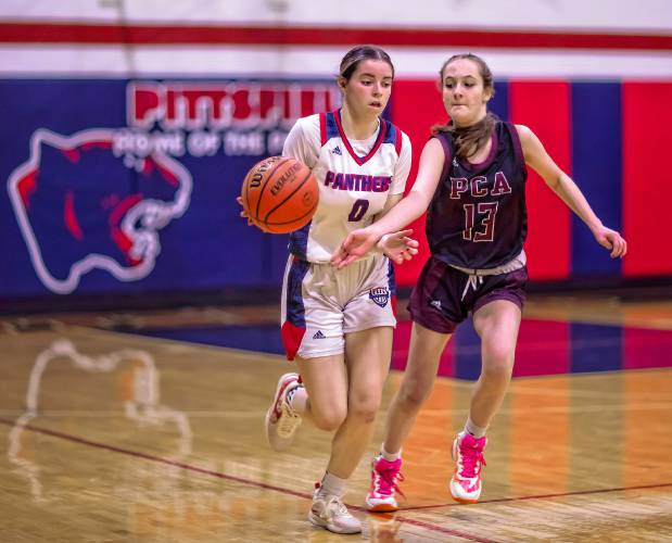 Pittsfield point guard Addison Clark fights off Portsmouth Christian Academy guard Ava Natale as she tries to steal the ball during the first half of a game on Tuesday evening.