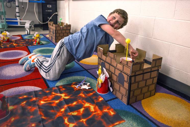 Student Cooper LeMire works on a castle game at Penacook Elementary School during the Mario Brothers-themed Escape Room during the family engagement party at the school on Thursday evening, March 27, 2025.