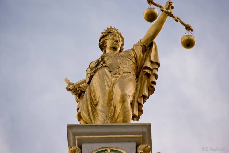 A statue of golden Lady Justice in Bruges, Belgium. A statue of golden Lady Justice in Bruges, Belgium.
