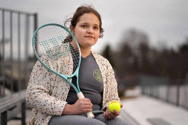FILE - Iris Turmelle, one of two New Hampshire transgender students who filed a lawsuit against state officials to stop the enforcement of the law which would prevent them from participating on their high school's girls' sports teams, poses at her school, March 5, 2025, in Pembroke, N.H. (AP Photo/Robert F. Bukaty, File)