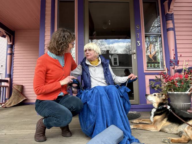 Barbara Filion and her daughter Marsha Filion enjoy a quiet morning on their front porch in Portsmouth with their neighbor's dog Buddy.