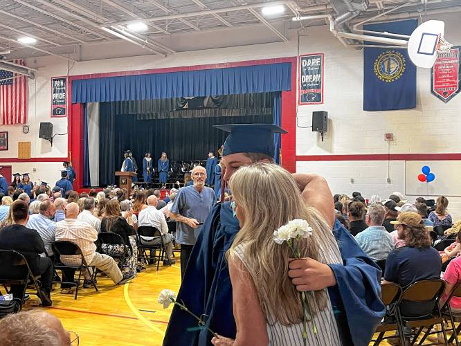 Pittsfield graduate Michael Casey gets a hug Saturday.