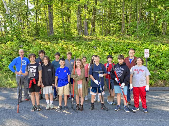 Chris Wood, left, and Tim Lamendola, right, with their seventh- and eighth-grade advisory students as they prepare to work on clearing the trail behind Belmont Middle School.