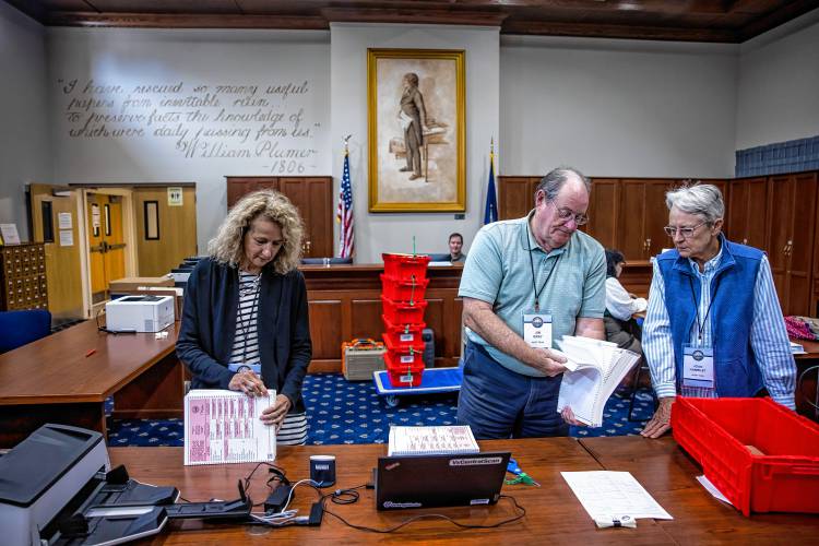 Senior Deputy Secretary of State Patricia Lovejoy (left), along with audit team members Jim Gray and Joan Hamblet prepare the ballots from Winchester to be fed into the high speed scanner at the State Archives in Concord on Wednesday, September 11, 2024.
