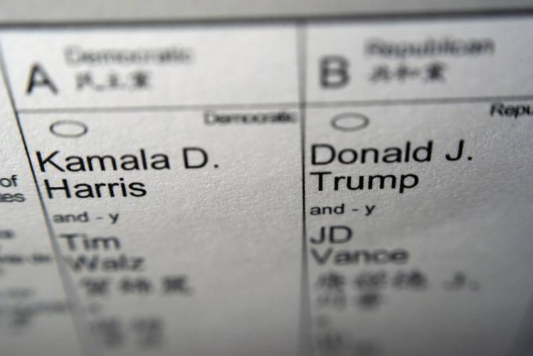 Candidates for president and vice president of the United States, Democrats Vice President Kamala Harris and Minnesota Gov. Tim Walz, and Republicans former President Donald Trump and Sen. JD Vance, R-Ohio, are seen on part of a mail-in election ballot in New York on Sunday, Nov. 3, 2024. (AP Photo/Patrick Sison)