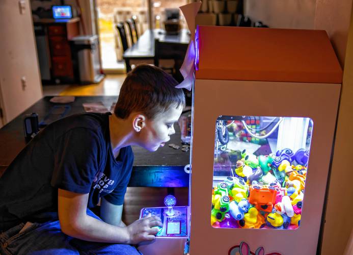 Kristen LeGeyt’s living room is a busy place but her son, Ryan does get a chance to play with one of the kids’ Christmas gifts on January 9, 2025 at their Concord home.