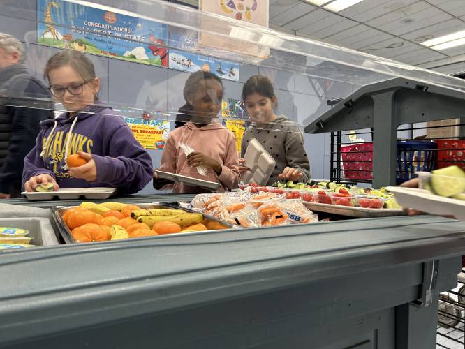 Students at Broken Ground School pick up their free grab-and-go breakfasts. 