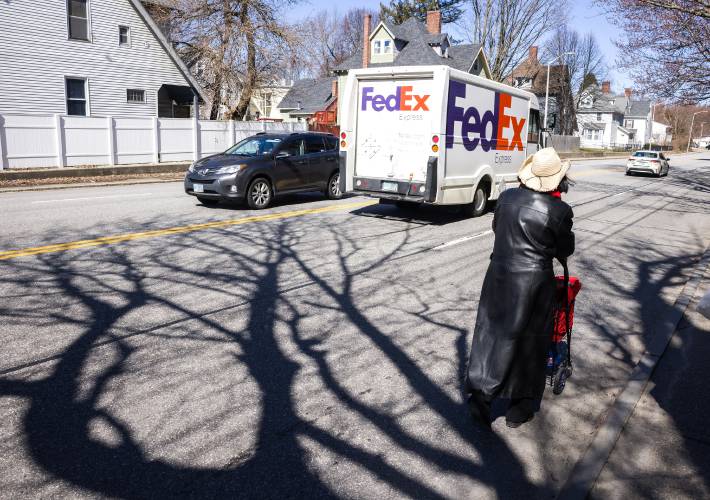 Deborah Eckland walks to the site of where her brother, Glen, was found dead in Manchester.
