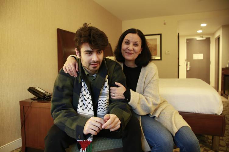 Tamara Tamimi and her son, Kinnan Abdalhamid, 20, speak about the Nov. 25, 2023, shooting that injured Kinnan and his two friends, an attack being investigated as a possible hate crime, during an interview Friday, Dec. 1, 2023, in Burlington Vt. The three friends, all college students of Palestinian descent, were shot at close range on a residential street in Burlington. (AP Photo/Hasan Jamali)
