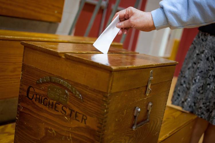 Attendees vote by secret ballot during Saturday's Chichester School District annual meeting at Chichester Central School on March 11, 2017.