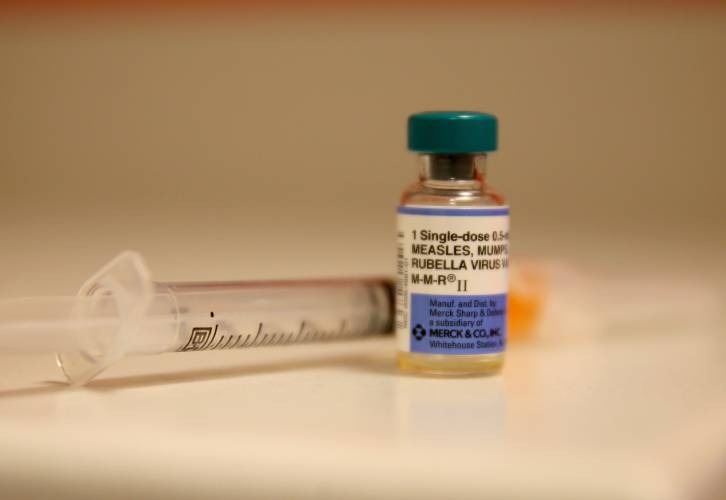 A bottle containing a measles vaccine. A bottle containing a measles vaccine.