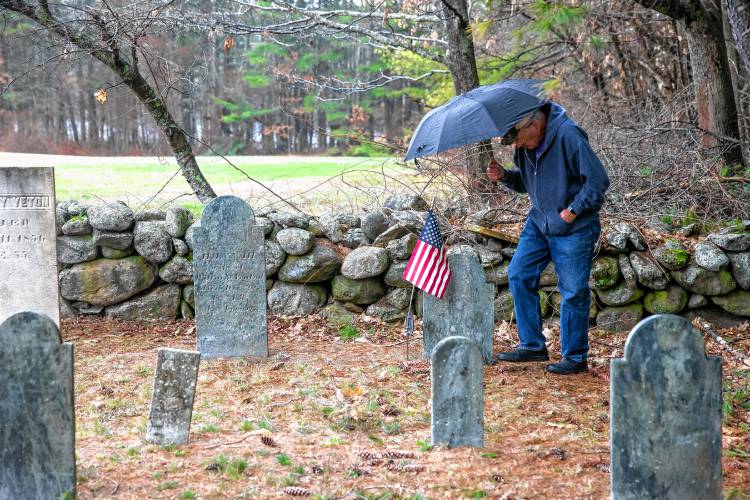 Norm Yeaton looks over a grave marker in the private Yeaton cemetery off of Black Hill Road in Dpsom on Thursday, April 11, 2024. Yeaton has taken on the arduous research project by Yeaton to understand the sheer volume of people in Epsom whose last name was the same as his--even when the name was Yeton before they added the ‘a’ sometime in the 19th century.