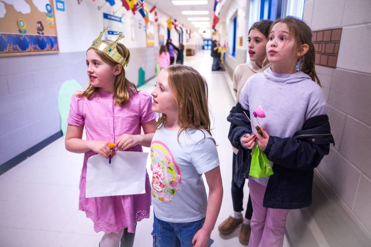 Sisters Sophie and Caitlyn Kleiner (left) and Alice and Molly Rudis walk in the hallways of Penacook Elementary School during the Mario Brothers-themed Escape Room on Thursday evening, March 27, 2025. The family engagement night had students and their families come and solve mysteries in the classrooms and enjoy pizza as well. 