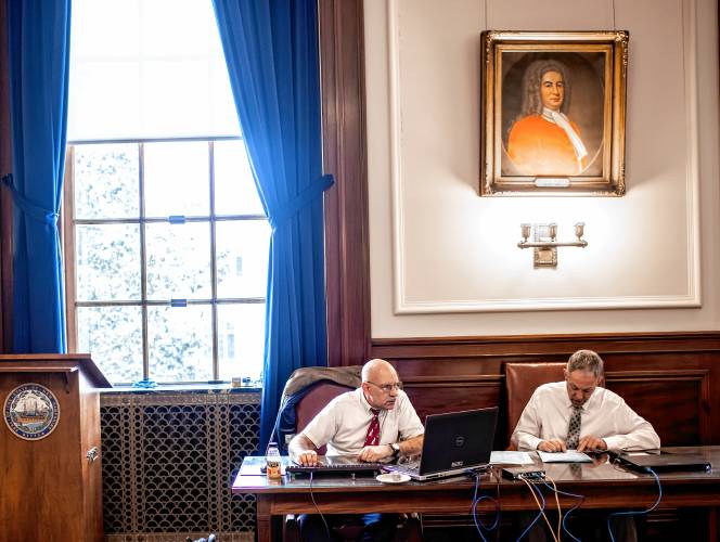 New Hampshire Secretary of State officials Dan Cloutier (left) and John Kiritsy check the ballots matching them with the electronic tallies in the Executive Council Chambers at the State House on the morning after the primary on Wednesday, January 24, 2024.