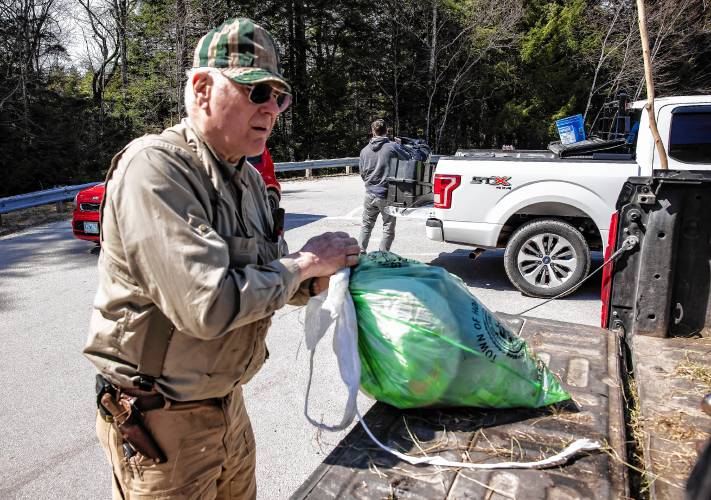 Brad Watson, a resident of Hopkinton for 50 years, gathers up his green bag for household items along with his agricultural waste items at the Hopkinton Transfer Station on Wednesday morning, April 17, 2024. Watson is not a fan of the green bags.