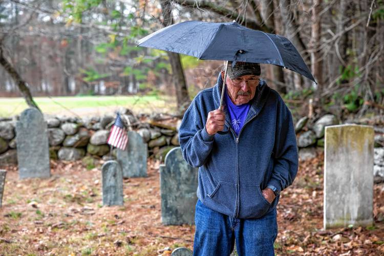 Norm Yeaton looks over the grave markers in the private Yeaton cemetery off of Black Hill Road in Dpsom on Thursday, April 11, 2024. Yeaton has taken on the arduous research project by Yeaton to understand the sheer volume of people in Epsom whose last name was the same as his--even when the name was Yeton before they added the ‘a’ sometime in the 19th century.