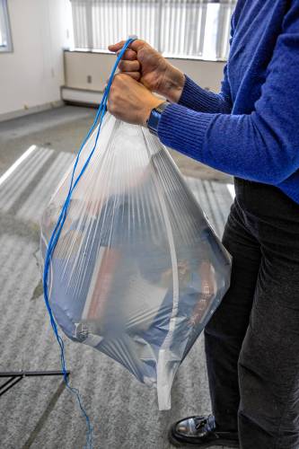 The store bought trash bag did hold up 40-pounds when it was secured around the top of the bag but not from the string attachment.