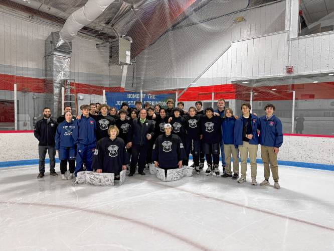 The John Stark-Hopkinton/Hillsboro-Deering hockey team poses with head coach Denis Kolehmainen (front center) after the General Hawks defeated Laconia-Winnisquam/Inter-Lakes, 5-3, on Tuesday for coach Kolehmainen's 150th career victory. Kolehmainen has been behind the General Hawks bench for 13 years.