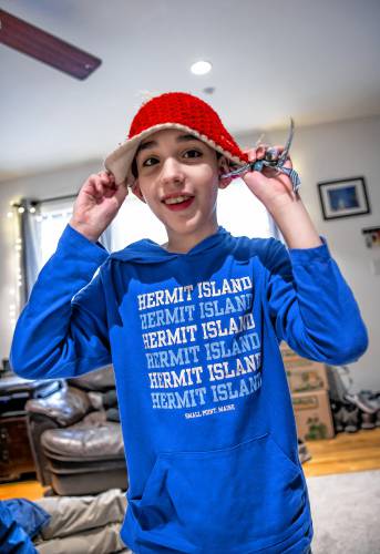 Kristen LeGeyt’s living room is a busy place with son Bryce and his brothers working on their school work on January 9, 2025. Bryce loves the ocean and is wearing a tee shirt from Hemit Island where he loves to go.