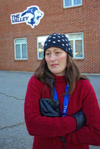  English teacher Mandy Tirrell stands out in the cold on Wednesday morning as she joins a group of Merrimack Valley High teachers that voiced their concerns about the proposed budget cuts.