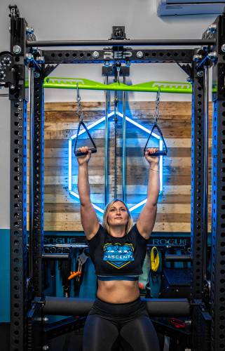 Anna Ferrara, co-owner at head trainer at Ascent Training and Performance, works the latissimus dorsi muscles, commonly known colloquially as the “lats,” at their facility Dec. 2.