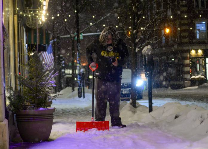 Jasmine Soneshine, a Brattleboro, Vt., resident, shovels a section of sidewalk on Main Street in Brattleboro as the snow falls on Tuesday, Jan. 9, 2024. (Kristopher Radder/The Brattleboro Reformer via AP)
