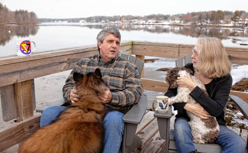 Dennis Pratt and his wife, Carol, enjoy their morning coffee on the deck of their condo near Dover Point in Dover on Thursday.