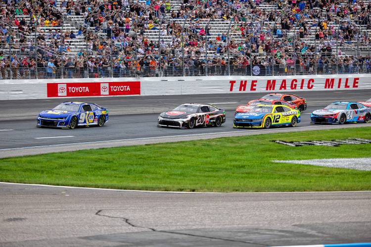 Chase Elliot lead Christopher Bell and the rest of the field through the first turn at the start of the USA Today 301 in Loudon.