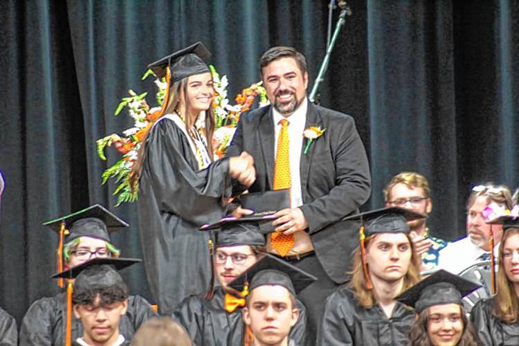 Conant Middle High School Principal David Dustin presents a diploma to Ella Weinhold during this year's graduation ceremony. Conant Middle High School Principal David Dustin presents a diploma to Ella Weinhold during this year's graduation ceremony.
