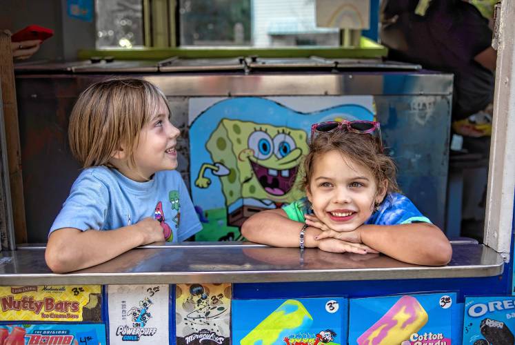 Maddy and Adam Gelserve serve up ice cream from their van in the neighborhood near where they live in Allenstown on Thursday evening, August 22, 2024. Their girls, Maisie (left), and Avery were there to help as well.
