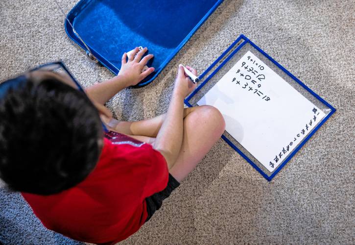  Greyson LeGeyt works on an addition game in the family living room on January 9, 2025.
