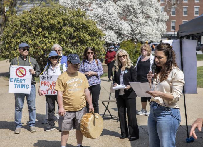 Seana Hallberg spoke to a group of around 100 people at a Hands Off Medicaid rally outside the State House on Thursday.