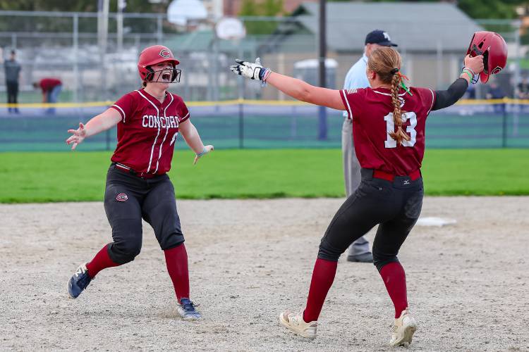 Sisters Kiley Taylor (left) and Maggie Taylor (right) run towards each other to embrace after the pair helped lead the Concord High School softball team to a 7-6 walk-off victory over Dover in eight innings on Friday at Memorial Field. Kiley hit a double to the left field wall that brought home Maggie for the game-winning run.
