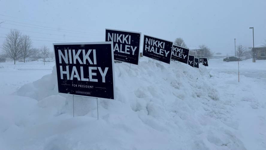 Nikki Haley campaign signs stand in a snowbank in Waukee, Iowa.