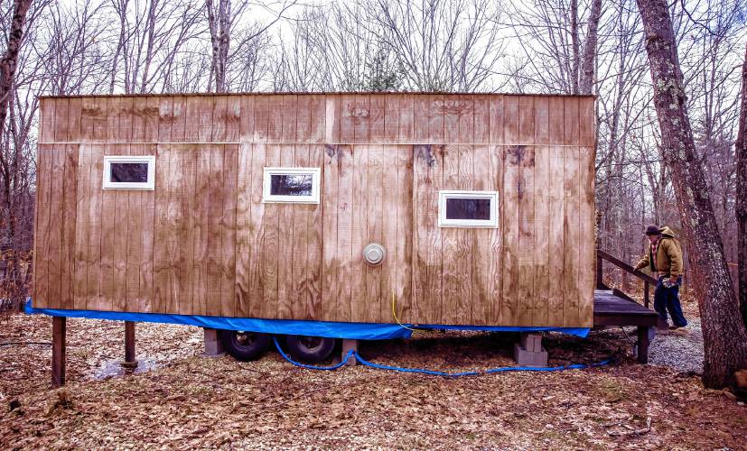 Woodworker David Emerson enters the tiny house he is modeling on his Canterbury property on Tuesday, March 12.