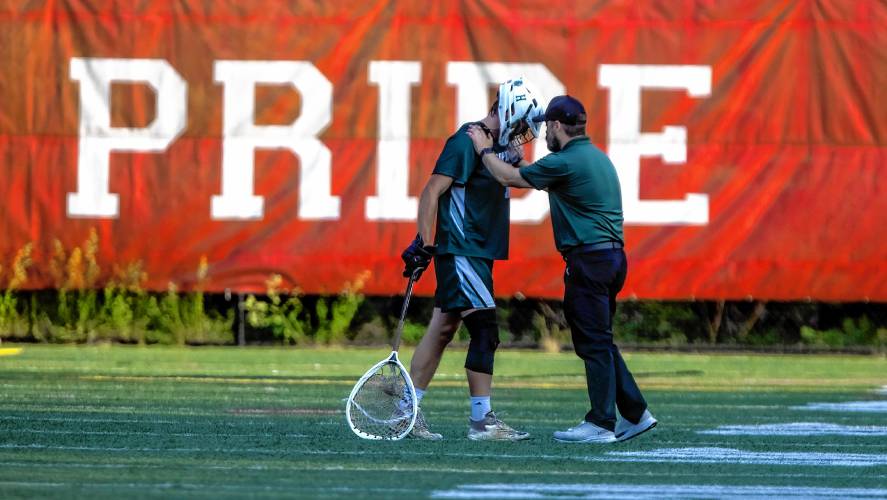 Hopkinton assistant boys’ lacrosse coach Kyle Detitte comforts goalie Colby Boissy after he was pulled from Wednesday’s D-III semifinal game with Campbell after aggravating a knee injury.